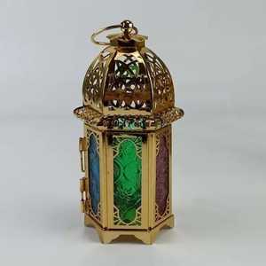 Intricate metal lantern pair patterned glass panels domed top ornate cutouts circular ring white pillar <b>candles</b> indoor outdoor - Product Image 1