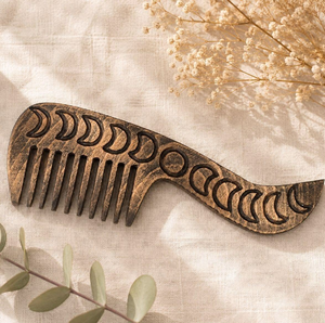 Rustic dark-stained <b>wooden</b> comb <b>carved</b> with complete moon phase cycle motifs along the handle, available at wholesale prices. - Product Image 1