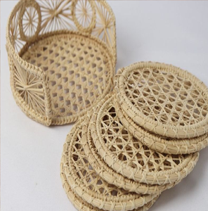 Natural woven rattan <b>drink</b> <b>coaster</b> set with hexagonal mesh patterns alongside a matching openwork holder, at wholesale prices. - Product Image 1