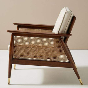 Sturdy single accent <b>chair</b> featuring woven rattan panels, a dark wood frame, and cream-colored tufted <b>cushions</b>. - Product Image 3