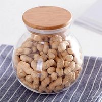 Pot en verre à finition lisse avec couvercle en bois pour un rangement élégant et un nettoyage facile, avec un verre robuste et un couvercle en bois.
