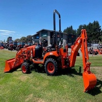 Tractor Kubota BX23S en buen estado con cargador frontal y retroexcavadora, implementos de cortacésped disponibles