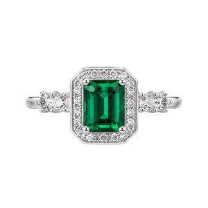 Elegant halo <b>ring</b> in 18K white gold with emerald cut green diamond micro pave halo and side diamonds luxury bridal couture desig - Product Image 1