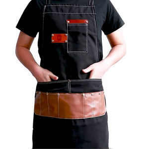 Delantal de Peluquería de Lona Negra con Bolsillos de Cuero, Duradero y Ajustable para Uso en Salón, Estilo Moderno, Color Personalizable - Product Image 1
