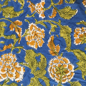 Tissu en coton imprimé à la main en Inde avec un motif floral moutarde et des feuilles vertes sur fond bleu roi - Product Image 1