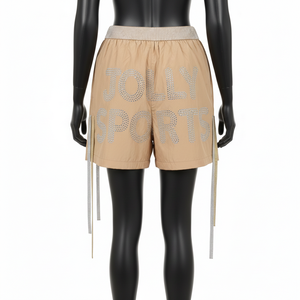 Shorts cortavientos de alta calidad para mujer, en nailon suave GSM, color beige arena, con logotipo de transferencia térmica con pedrería. - Product Image 2