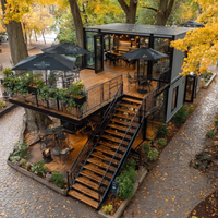 Restaurant en conteneur noir à deux étages EC-20TP avec terrasse en bois pour projets commerciaux
