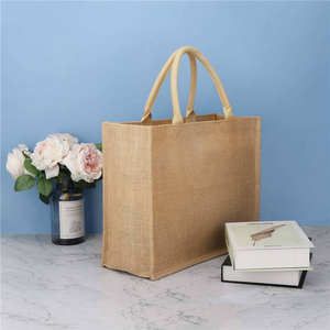Bolsa de almuerzo sostenible de yute con bolsillo frontal y correa ajustable - Product Image 1