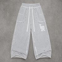 Pantalon de survêtement ample perlé gris chiné en coton à jambe large avec cordon de serrage, bords bruts et poches plaquées, style streetwear OEM ODM