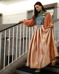 Luxurious <b>White</b> Silk Long <b>Maxi</b> Dress Featuring Intricate Gold Thread Embroidery On Bodice And High Neck With Oversized Billowing - Product Image 3
