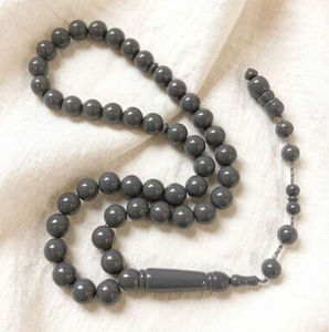 Warm amber-<b>toned</b> smooth round tasbih prayer beads attached to an elegant matching <b>red</b> cord, available at wholesale prices. - Product Image 4