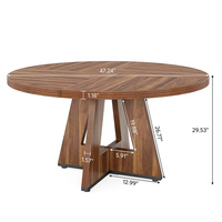 Table à manger ronde moderne en bois, finition noyer, base croisée de style mid-century
