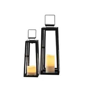 Black metal <b>lantern</b> <b>set</b> with glass panels pyramid top circular ring white pillar candles red and pink flower petals - Product Image 2