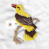 Serviette en lin avec oiseau jaune, les surpiqûres vives rehaussent le décor festif.