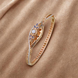 Bracelet élégant en or rose avec moissanite, accents floraux bleus, finition polie, design filigrané, bijou de déclaration de luxe - Product Image 1