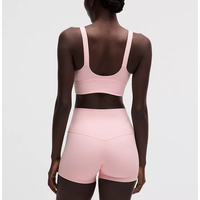 Ensemble de yoga rose sans couture pour femme, composé d'un crop top à col rond et d'un short taille mi-haute, avec soutien-gorge de sport convertible à bretelles en Spandex/Nylon, idéal pour l'entraînement.