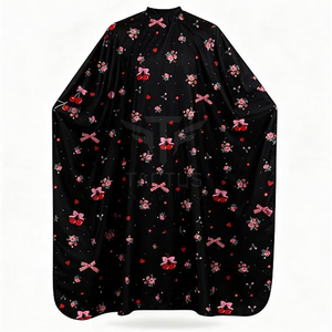 Cape de coiffure noire à imprimé floral cerise, en polyester anti-adhérent, avec fermeture à bouton-pression réglable - Product Image 1