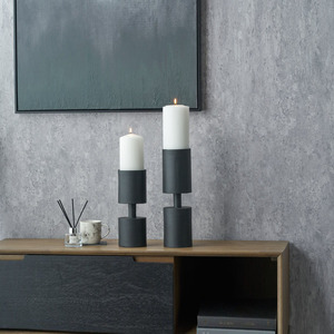 Modern Matte <b>Black</b> <b>Pillar</b> <b>Candle</b> <b>Holder</b> Featuring A Cylindrical Design And Thick Stem Holding A Tall White <b>Candle</b> For Home Decor - Product Image 4