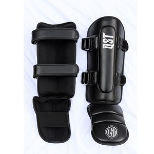 Espinilleras QST de Piel Sintética Acolchada para Muay Thai, MMA, Artes Marciales, Entrenamiento, Ligeras, con Cierre de Hebilla - Product Image 1