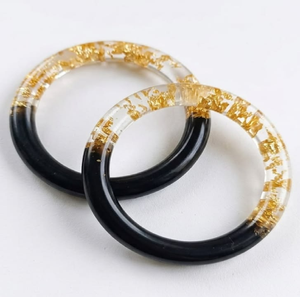 Pair of <b>clear</b> <b>resin</b> bangles infused with crushed deep magenta flower petals, available at wholesale prices. - Product Image 3