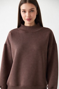 Stylish woman in bright bubblegum <b>pink</b> mockneck <b>sweatshirt</b> featuring elegant lace details on neckline and hem with oversized rel - Product Image 6