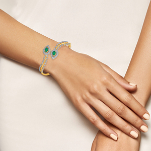 Elegant Gold <b>Bangle</b> <b>Bracelet</b> with Emerald Teardrop Gemstones, Diamond Leaf Motifs, and Luxurious Pavé Detailing - Product Image 3