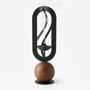 Modern <b>Incense</b> <b>Cone</b> <b>Burner</b> Featuring A Sculptural Matte Black Oval Frame And A Warm Wooden Sphere Base Emitting Fragrant Smoke - Product Image 1