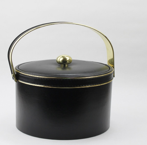 Vintage mid-century modern black leatherette ice bucket featuring a brass handle. Available at wholesale price. - Product Image 1
