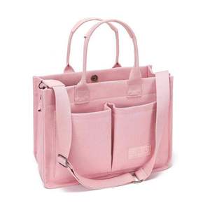 Sac fourre-tout rose, semblable à un sac en toile de la marque ZHMO, doté d'un design structuré et de poches avant. - Product Image 1