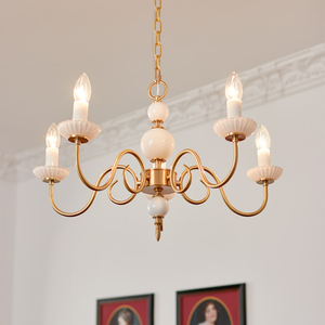 Classic brass <b>candle</b> <b>chandelier</b> styled with white ceramic accents and scalloped cups, available at wholesale prices. - Product Image 1