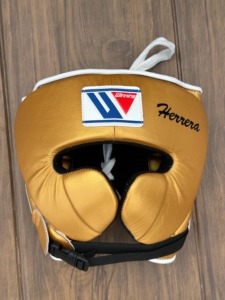 อุปกรณ์ป้องกันศีรษะสำหรับชกมวย รุ่น Winning Boxing Head Guard Gold สำหรับฝึกซ้อมและแข่งขัน MMA ผลิตจากหนังคุณภาพพรีเมียม ระบายอากาศได้ดี สวมใส่สบาย พร้อมตัวล็อคแบบหัวเข็มขัด สำหรับผู้ใหญ่ - Product Image 1