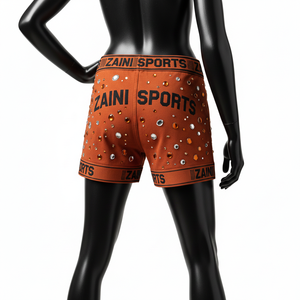 Shorts pour femmes en tissu polyester et élasthanne hautement extensible, toucher doux, couleur rouille, logo en cristal thermocollé. - Product Image 2