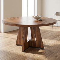 Table à manger ronde moderne en bois, finition noyer, base croisée de style mid-century