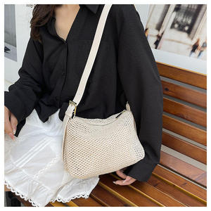 Diffusez une élégance moderne avec ce sac chic en fil naturel, doté d'un design tissé structuré et d'une bandoulière en cuir réglable. - Product Image 2