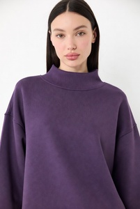 Stylish woman in bright bubblegum <b>pink</b> mockneck <b>sweatshirt</b> featuring elegant lace details on neckline and hem with oversized rel - Product Image 3