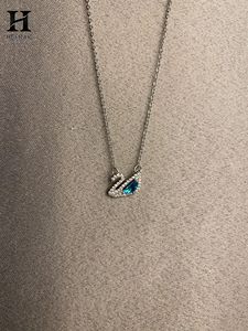 Collier pendentif élégant en forme de cygne avec pierres précieuses bleues et diamants – Bijoux raffinés par Heerak Diamonds - Product Image 2