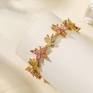 Elegant Gold Tone Bracelet Featuring <b>Pink</b> <b>Petal</b> Details And Clear Sparkling Accents For Retailers And Resellers - Product Image 1