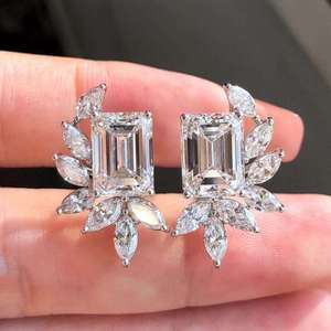 Radiant <b>emerald</b> solitaire <b>stud</b> <b>earrings</b> with marquise diamond accents in floral leaf setting refined luxury jewelry for women - Product Image 5
