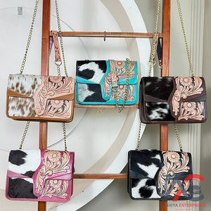 Wholesale Handmade Genuine Leather Black & White Hair On Cowhide Crossbody Bag with Hand Tooled Floral Design Messenger Bags - Product Image 1