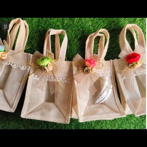 Handcrafted Eco-Friendly Jute Favor Bags with Transparent <b>Windows</b> and Floral Accents Exquisite Handcrafted Jute Favor Bags - Product Image 1
