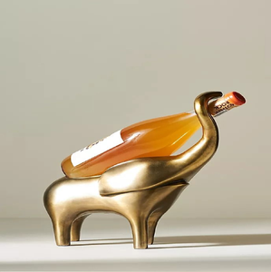Elegant golden elephant figurine wine bottle holder holding bottle <b>trunk</b>, available at wholesale prices. - Product Image 1
