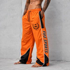 Pantalon de survêtement coupe-vent pour homme, bas de tenue haute performance conçu avec un matériau léger et à séchage rapide pour l'exercice et la course à pied - Product Image 1