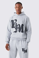 Ensemble de survêtement streetwear personnalisé délavé à l'acide, comprenant un sweat à capuche zippé et un pantalon de survêtement évasé avec patchs effet vieilli