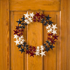 Patriotic Star Wreath Featuring Clusters Of Dimensional Metal Stars Painted In Modern Red, White, And Navy Blue Tones For Decor - Product Image 1