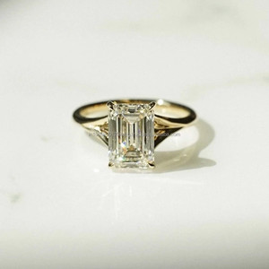 Luxurious Emerald Cut <b>Solitaire</b> Engagement <b>Ring</b> In Classic Gold Band With Minimalist And Sophisticated Design - Product Image 1