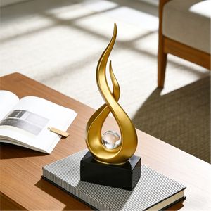 Sculpture abstraite de flamme dorée de luxe avec boule de cristal transparente, figurine d'art moderne en résine, élégante décoration de table pour salon - Product Image 1