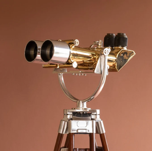 Heavy-duty polished brass and chrome big ocular naval binocular mounted on a wooden floor tripod, available at wholesale prices. - Product Image 1