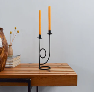 Elegant minimalist gold iron scrollwork dual candle stand holding two clear glass tealight cups. Available at wholesale price. - Product Image 2