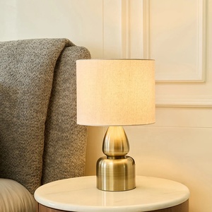 Aurora Sculpted Metal Table <b>Lamp</b> with Linen Drum Shade Antique Brass Finish Soft Ambient Lighting for Elegant Interiors - Product Image 3