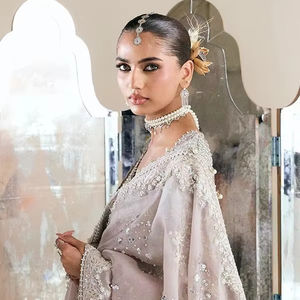 Premium Pakistani Bridle Dress Back View Of Soft Peach Pink Pastel Layered Farshi Lehnga Showcasing Heavily Embellished Long - Product Image 1